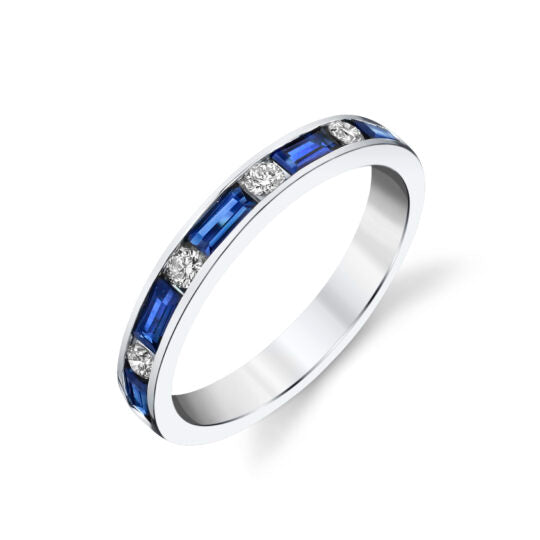 Photo of Blue Sapphire Baguette and Diamond Band in a decorative scene, designed by , available at Plumb Gold & Plumb Silver