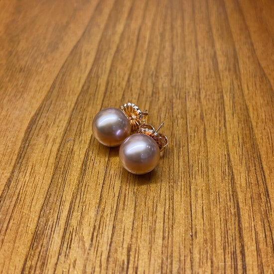 Photo of Edison Pearl Studs in a decorative scene, designed by , available at Plumb Gold & Plumb Silver