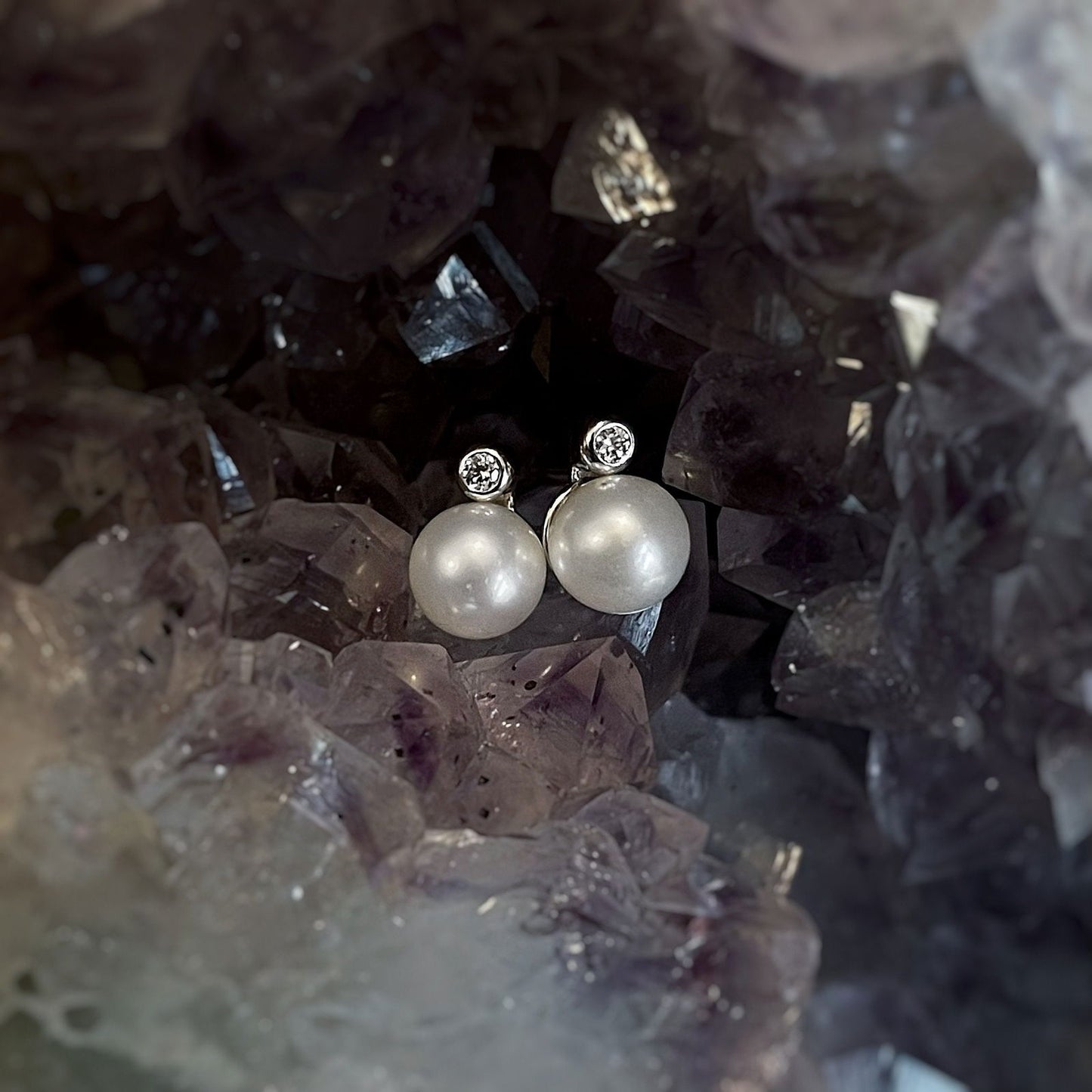 Photo of Pearl and Diamond Studs in a decorative scene, designed by , available at Plumb Gold & Plumb Silver