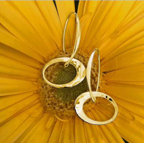 Photo of "Petite Elliptical" Earrings in a decorative scene, designed by , available at Plumb Gold & Plumb Silver