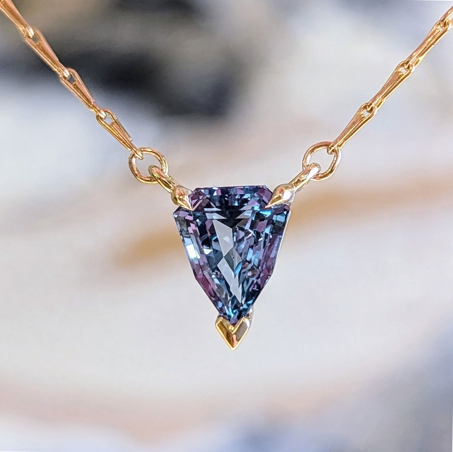 Photo of Pincetta Sapphire Necklace in a decorative scene, designed by , available at Plumb Gold & Plumb Silver