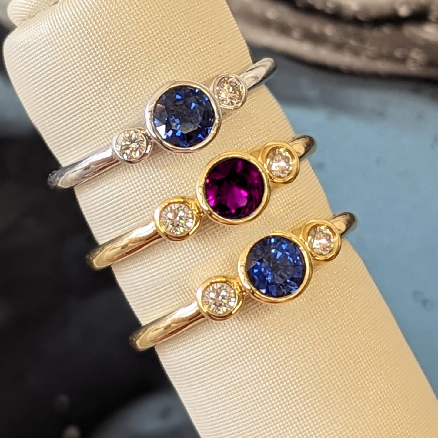 Blue Sapphire and Diamond Three Stone Bezel Ring